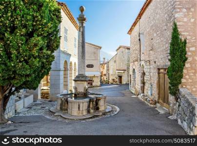 GOURDON, FRANCE - OCTOBER 31, 2014: Medieval street with a fountain in the village
