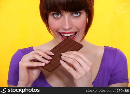 Gourmand woman eating chocolate