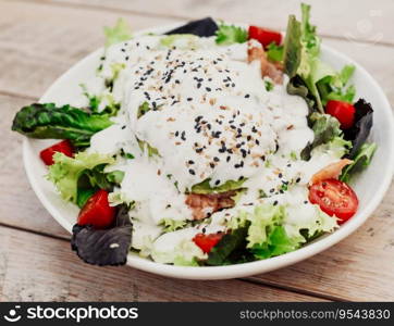 Gourmet plate of Caesar salad with chicken, parmesan, and crusty bread