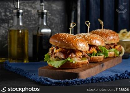 Gourmet Pulled Pork Burger with with Coleslaw and barbecue Sauce on Wooden Table.