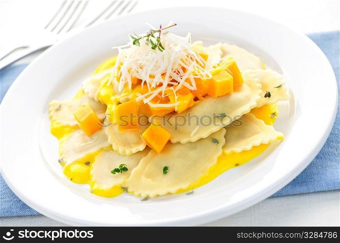 Gourmet squash ravioli dinner served with cheese on plate