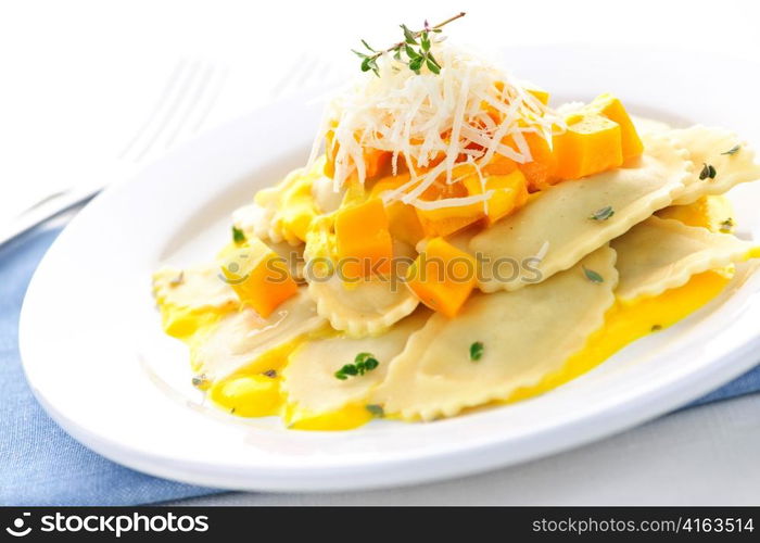 Gourmet squash ravioli dinner served with cheese on plate