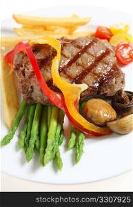 Gourmet style veal sirloin steak, served with asparagus, grilled mushrooms, cherry tomatos, ribbons of red and yellow capsicum and fries.