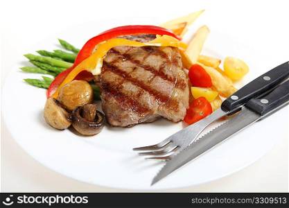 Gourmet style veal sirloin steak, served with asparagus, grilled mushrooms, cherry tomatos, ribbons of red and yellow capsicum and fries, with a steak knife and fork