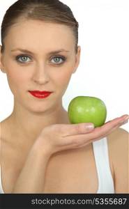graceful ballerina with bright red lipstick holding green apple