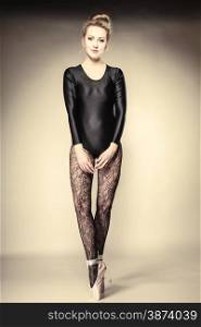 Graceful beautiful woman ballet dancer full length studio shot gray background