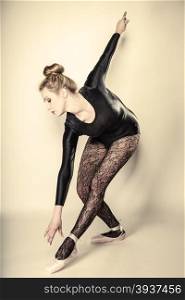 Graceful beautiful woman ballet dancer full length studio shot gray background