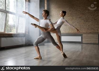 Graceful classic ballet duet performing indoors. Contemporary choreography dancers in action. Graceful classic ballet duet, contemporary choreography dancers