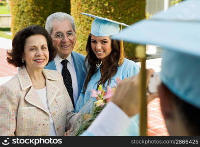 Graduate Posing for Picture with Parents