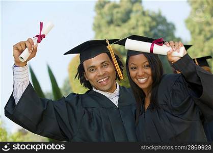 Graduates Holding Diplomas
