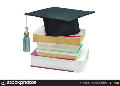 Graduation cap on top of a stack of books isolated on white