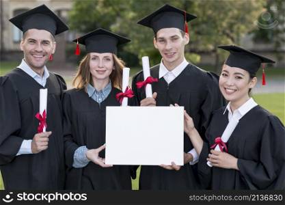 graduation concept with students holding blank certificate template