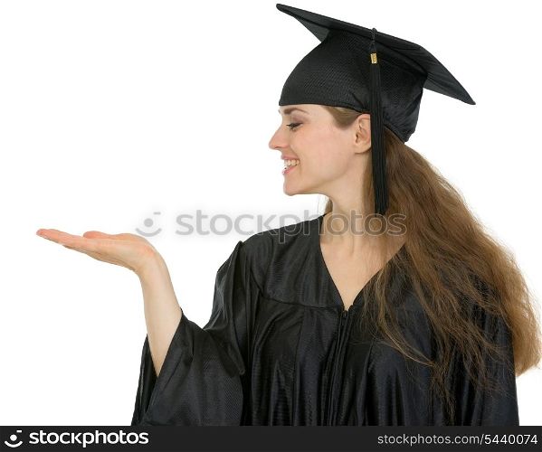 Graduation student woman showing something on empty hand