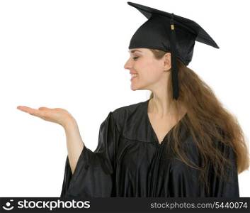 Graduation student woman showing something on empty hand
