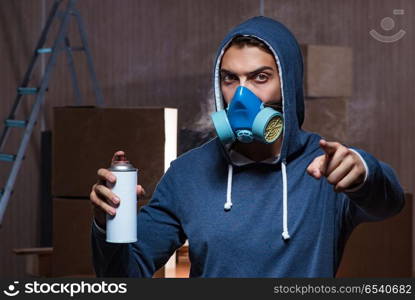 Graffiti painter in dark smokey room