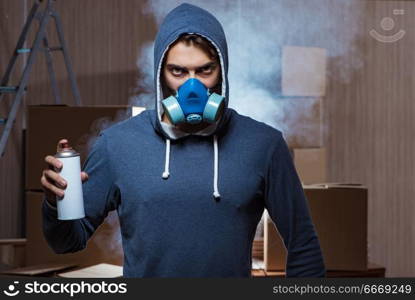 Graffiti painter in dark smokey room