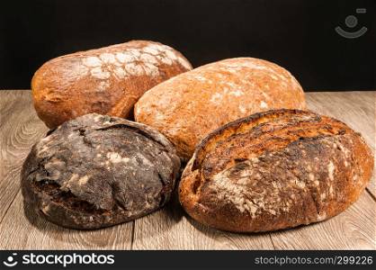 grain bread and fig bread with prunes on dark background