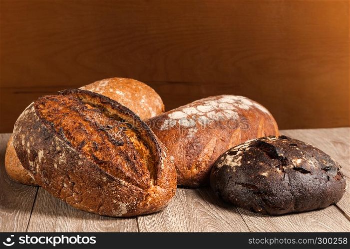 grain bread and fig bread with prunes on wooden background