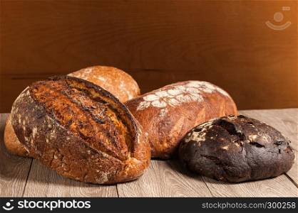 grain bread and fig bread with prunes on wooden background