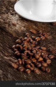 Grains and a cup of black coffee on a wooden background