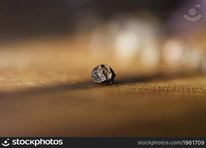 grains of black pepper on the table