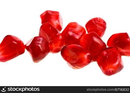 grains of pomegranate close-up isolated on white