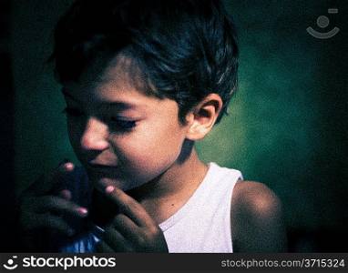 grainy film shot imitation - boy indoors closeup, focused light on the one side