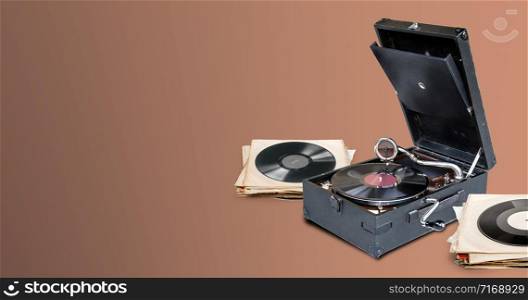 gramophone playing a vinyl record on brown background