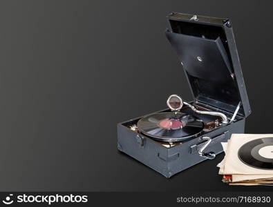 gramophone playing a vinyl record on brown background