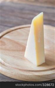 Grana Padano cheese on the wooden board