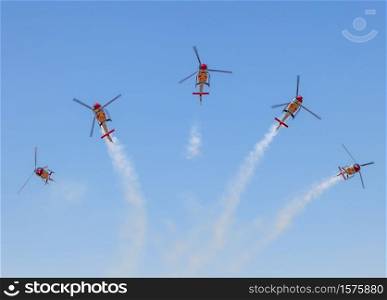 GRANADA, SPAIN-MAY 18: Helicopters of the Patrulla Aspa taking part in a exhibition on the X Aniversary of the Patrulla Aspa of the airbase of Armilla on May 18, 2014, in Granada, Spain. Patrulla Aspa