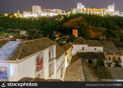 Granada. The fortress and palace complex Alhambra.. Walls and towers of the fortress of the Alhambra at night in Granada. Andalusia. Spain.