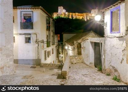 Granada. The fortress and palace complex Alhambra.. Walls and towers of the fortress of the Alhambra at night in Granada. Andalusia. Spain.