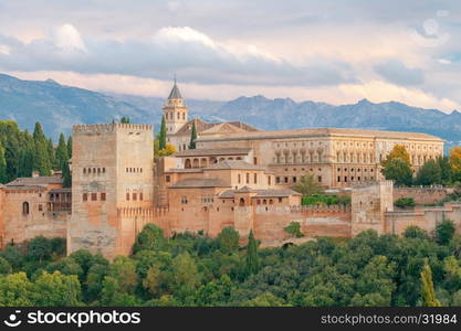 Granada. The fortress and palace complex Alhambra.. Walls and towers of the fortress of the Alhambra at sunset in Granada. Andalusia. Spain.