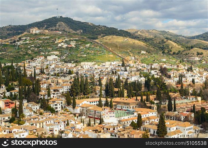 Granada view Andalucia, Espana. Panoramic view of Granada city against mountains, Andalusia, Spain