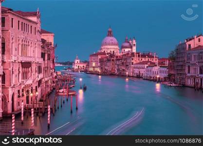 Grand canal and The Basilica of St Mary of Health or Santa Maria della Salute at sunset at night, Italy. Santa Maria della Salute, Venice