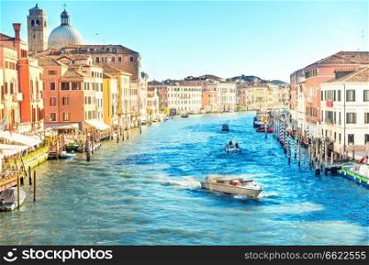 Grand canal in Venice - city travel landscape with boats and gondola