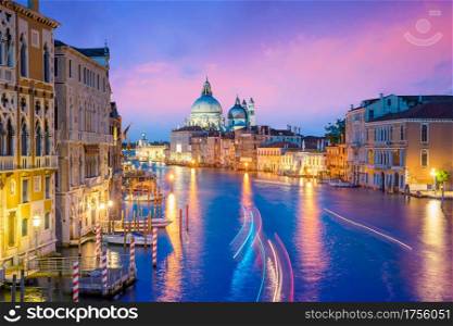 Grand Canal in Venice, Italy with Santa Maria della Salute Basilica in the background at twilight