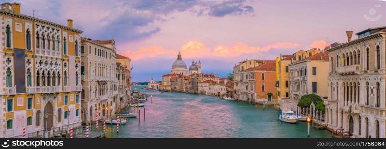 Grand Canal in Venice, Italy with Santa Maria della Salute Basilica in the background at twilight
