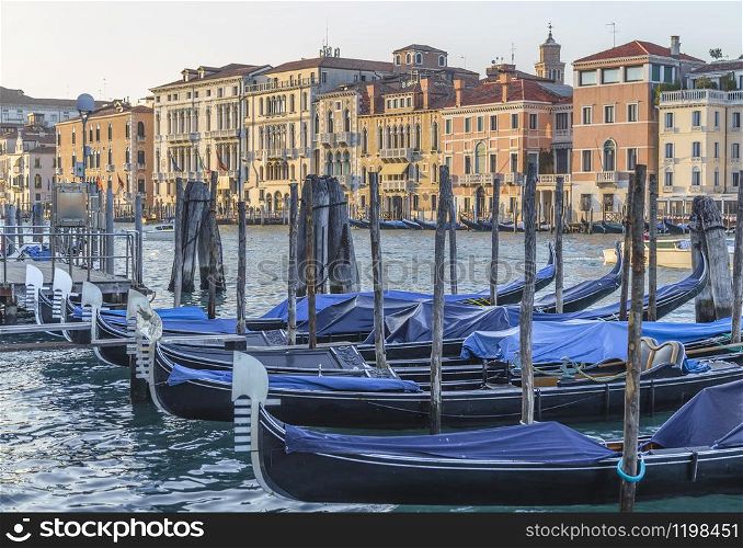 Grand Canal in Venice with parked gundoles and chic palaces. Italy