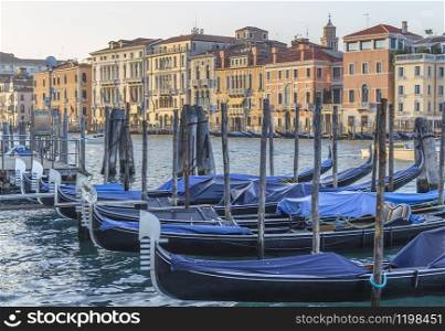 Grand Canal in Venice with parked gundoles and chic palaces. Italy