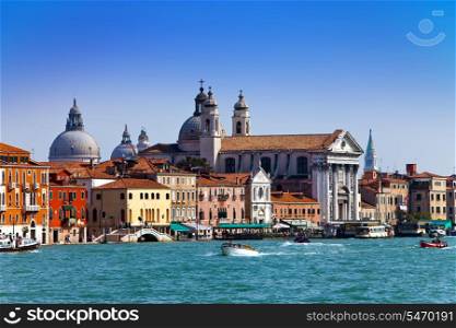 Grand Canal with boats and Basilica Santa Maria della Salute, Venice, Italy