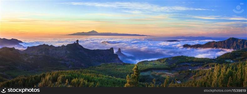 Grand Canary island. Mirador Roque Nublo . Breathtaking mountains over sunset and view of Tenerife .. Gran Canaria mountains over clouds. Canary islands of Spain