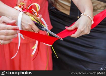 Grand opening. scissors cut the red ribbon. close-up
