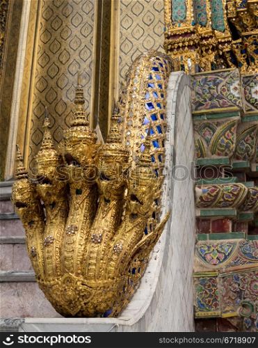 Grand Palace in Bangkok Thailand with ornate multi headed Naga or cobra snakes