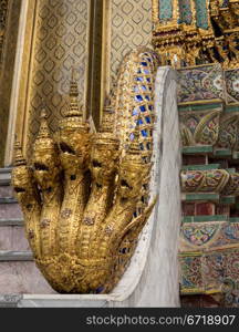 Grand Palace in Bangkok Thailand with ornate multi headed Naga or cobra snakes