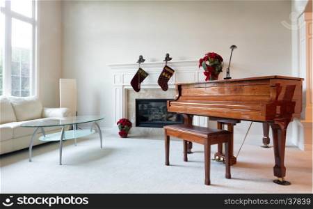 Grand piano surrounded by Christmas objects during with bright daylight coming through the living room window.