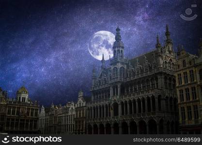 Grand Place - the historic square in the center of Brussels.The stars and the moon shine at night.. The stars and the moon shine at night.
