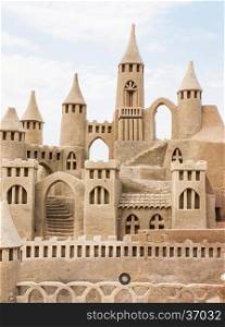 Grand sandcastle on the beach during a summer day