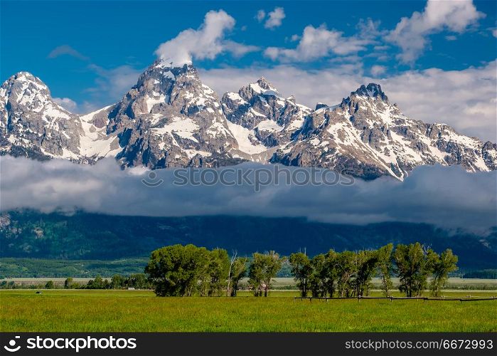 Grand Teton Mountains with low clouds. Grand Teton Mountains with low clouds. Grand Teton National Park, Wyoming, USA.